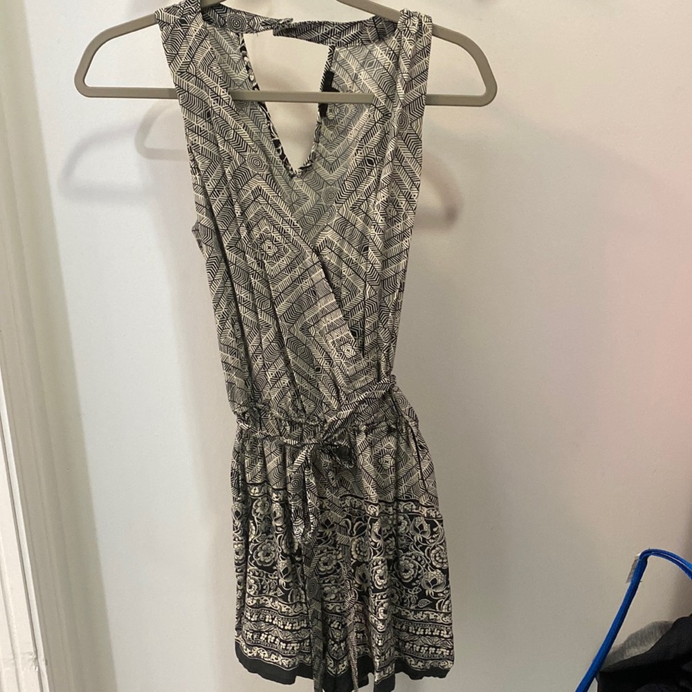 Black and white patterned romper with belt. V-cut I’m the front and back.